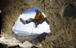 Grimpeur Pete Athans regarde à l'intérieur d'une grotte trouvée près Chuksang. On ne sait pas comment les gens montaient dans les grottes qui sont creusées dans une falaise au-dessus 155foot le fond de la vallée 