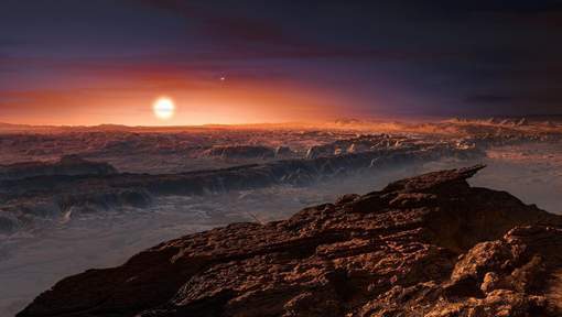 A hand out image made available by the European Southern Observatory on August 24 2016, shows an artist's impression of a view of the surface of the planet Proxima b orbiting the red dwarf star Proxima Centauri, the closest star to the Solar System. The double star Alpha Centauri AB also appears in the image to the upper-right of Proxima itself. Proxima b is a little more massive than the Earth and orbits in the habitable zone around Proxima Centauri, where the temperature is suitable for liquid water to exist on its surface.  Scientists on August 24, 2016 announced the discovery of an Earth-sized planet orbiting the star nearest our Sun, opening up the glittering prospect of a habitable world that may one day be explored by robots. Named Proxima b, the planet is in a "temperate" zone compatible with the presence of liquid water -- a key ingredient for life.   / AFP PHOTO / EUROPEAN SOUTHERN OBSERVATORY / M. Kornmesser