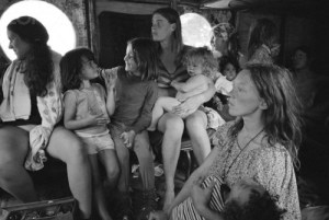 ca. August 15-17, 1969, Near Bethel, New York, USA --- Hog Farm members ride in a bus to the free Woodstock Music and Art Fair. About 450,000 people attended the three day concert, which turned into chaos due to the crowds, heavy rains, and traffic jams. It is nonetheless romantically remembered as a symbol of the liberal spirit of the hippie generation.  The Hog Farm collective ran the free kitchen and the "Freak-Out Tent" for people tripping on hallucinogens. --- Image by © Henry Diltz/CORBIS